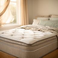 Natural hybrid mattress dressed in linen beside a sunlit window